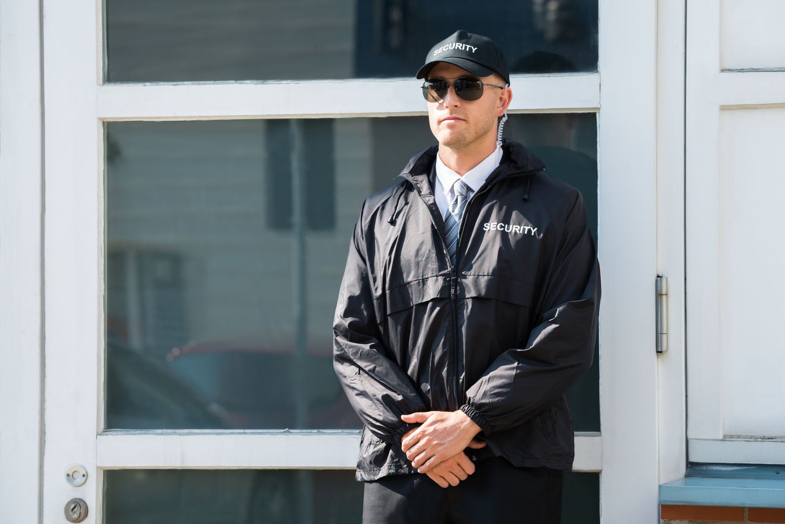 Uniformed security officer standing watch at a building entrance